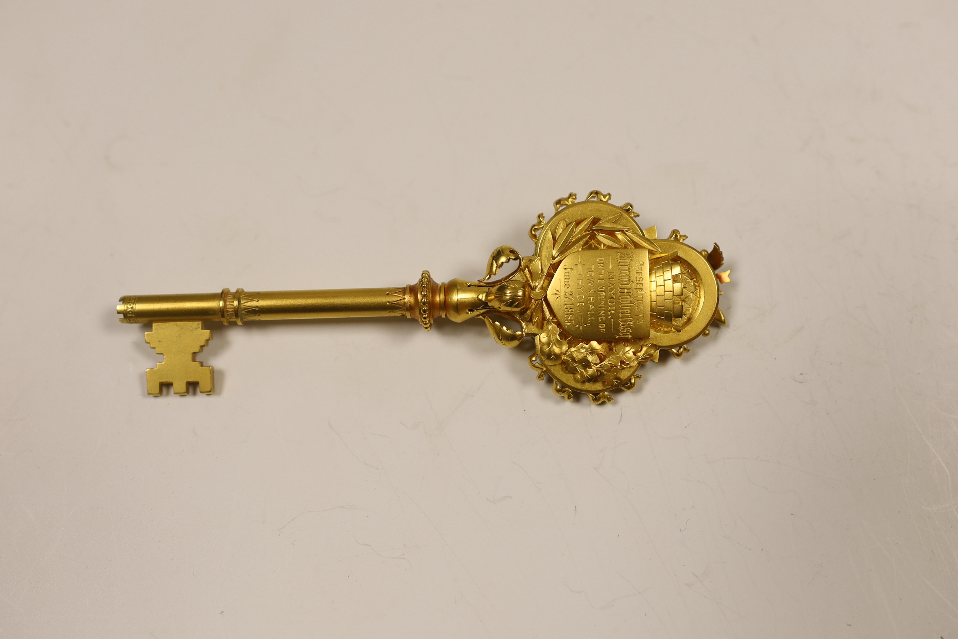 A cased Victorian gilt and polychrome enamelled presentation key, makers mark, M&M, 11.7cm, with engraved inscription relating to the presentation to Mayor Edward Hibbett, on the opening of the Town Hall in Hyde.